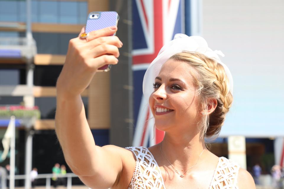  A pretty blonde racegoer was caught taking a selfie in the sunshine after making her way into the grounds