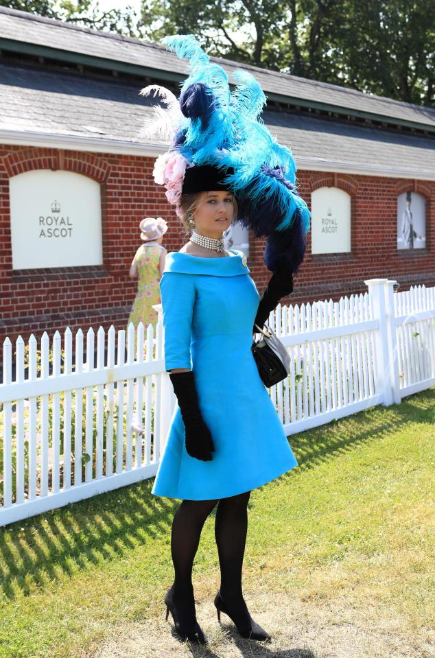  Barrister Edite Ligere looked glam in a navy and electric bloom feathered hat, a matching dress and black boots