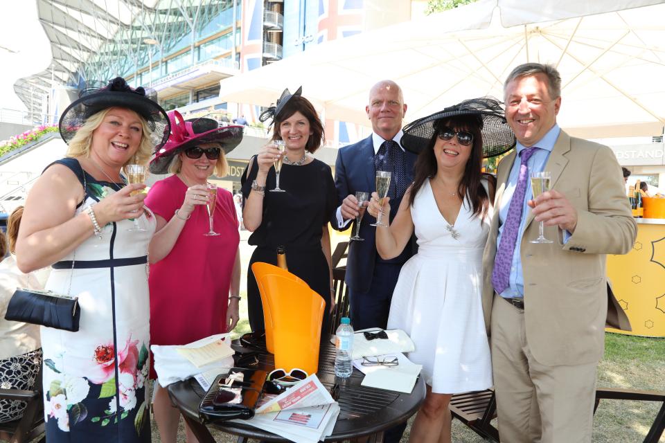  High-spirited revellers enjoyed a glass of bubbly ahead of the first race of the day