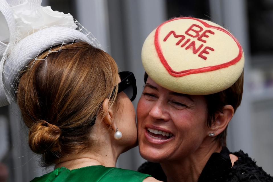  Racegoers were spotted greeting one another with a kiss on the cheek, as one donned a quirky Love Heart 'Be Mine' hat