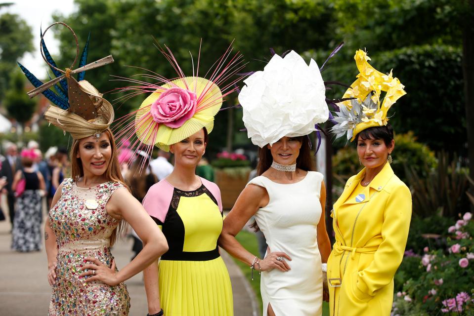  Four female friends posed for photographers in an array of head-turning designs, including a bright yellow two-piece suit and a gold sequin-adorned dress