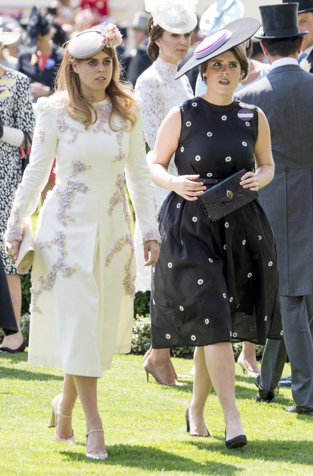  Princess Eugenie, right, opted for a black dress which was adorned in white flowers, while her sister Princess Beatrice glammed up in a white coat that was covered in pink jewels