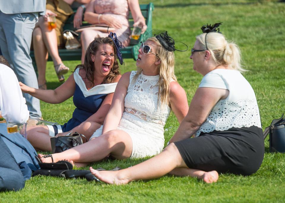  Three pals were spotted in hysterics while basking in the sunshine on the grass