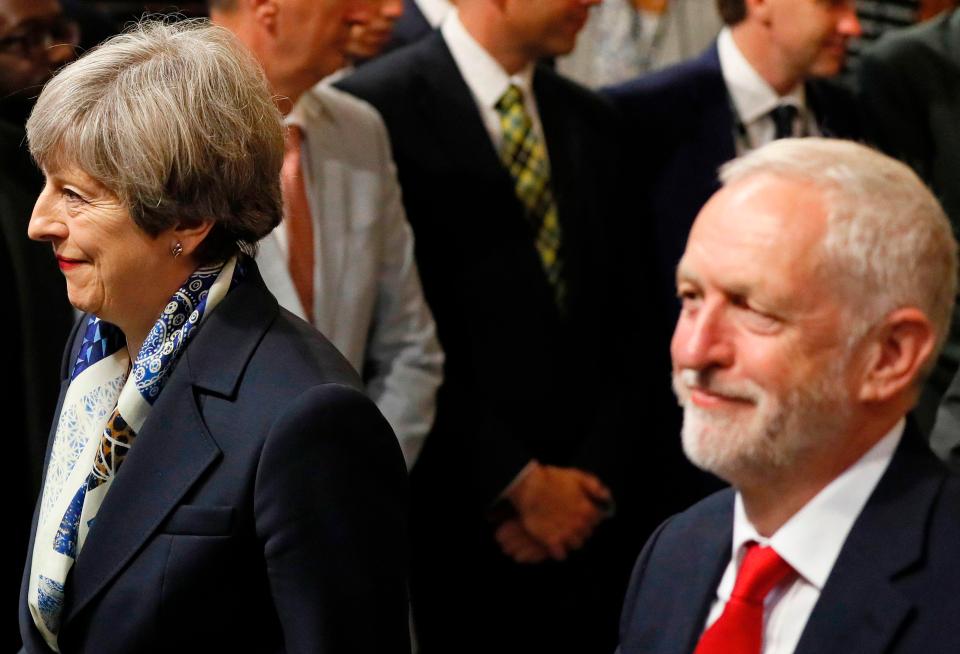  May and Corbyn stand watching the speech today