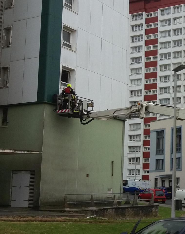  Firefighters remove a cladding panel from Lynher Tower in Devonport