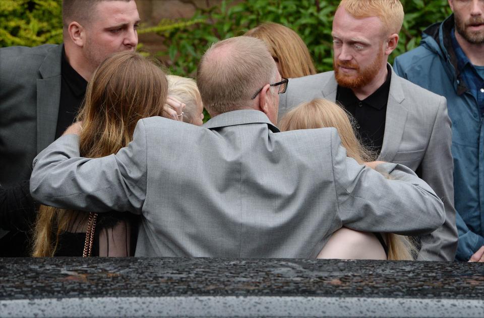  Alison's husband Steve held daughters Sasha and Darcey outside the church