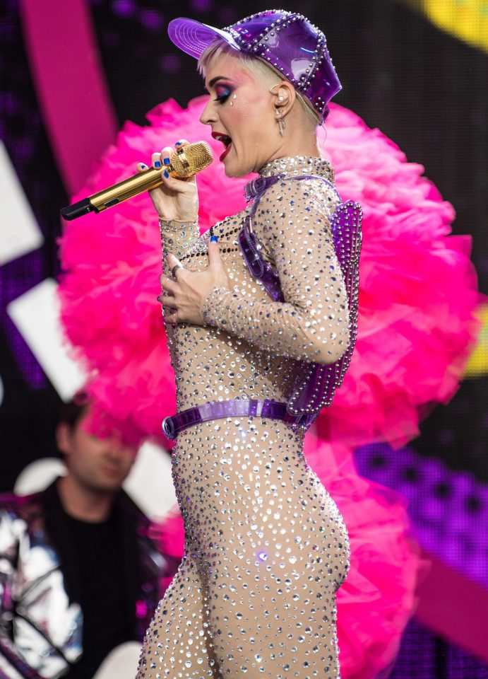  Katy Perry certainly stood out in her glitzy jumpsuit and studded purple baseball cap