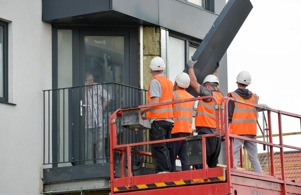  Workers remove cladding from the outer walls of Kennedy Gardens, a tower block in Billingham, Teesside