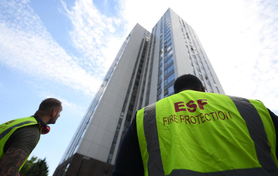  Fire protection workers stand outside the Chalcots Estate in Camden, north London