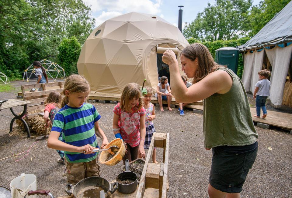  A teacher plays with the children at the school - where pupils are taught inside a yurt