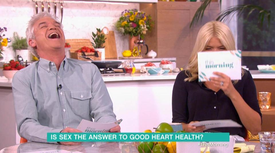  Holly hid her face behind her card as Phillip and Dr Chris joked about sex