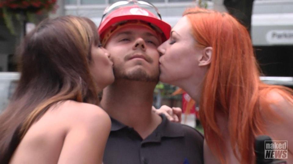  Another thirsty punter gets a kiss from the topless beauties