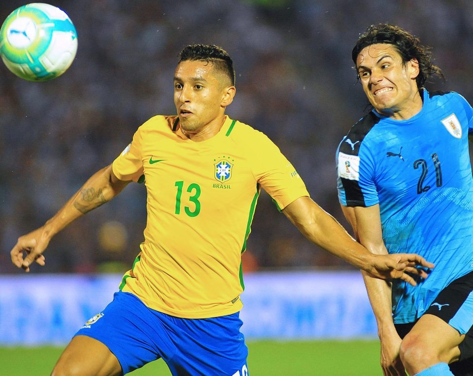 Marquinhos views foir the ball with Uruquay's Edinson Cavani