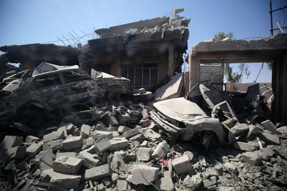  A damaged street and vehicles as Iraqi forces advance through the Old City of Mosul