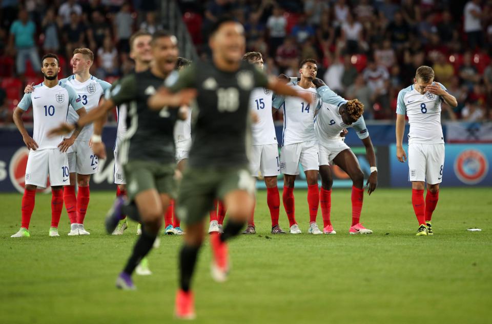  England players react at the half-way line as their German opponents sprint for the penalty area