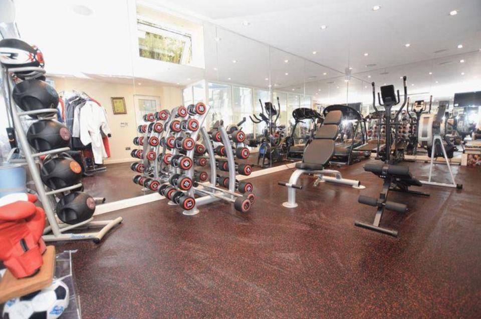  The fully-equipped gym is kitted out with weights as well as boxing gloves and robes