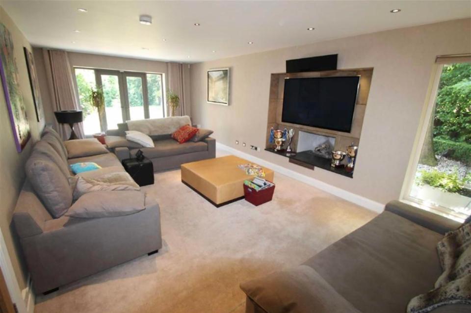  Inside the property is a spacious living area with a home cinema