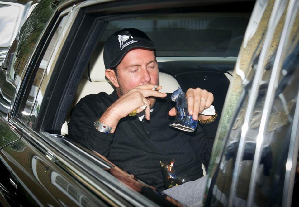  Stunt, 35, puffs a cig with glass ornaments on his lap