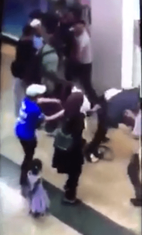  A woman is sent flying during the brawl