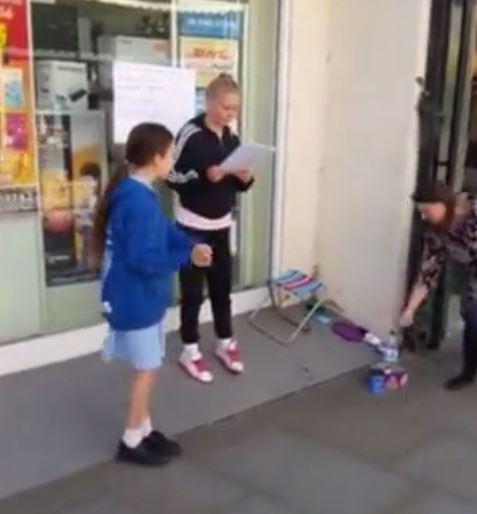  One member of the public donates to Anna-Athene Bown-Lowe's money tin in Wells city centre, Somerset