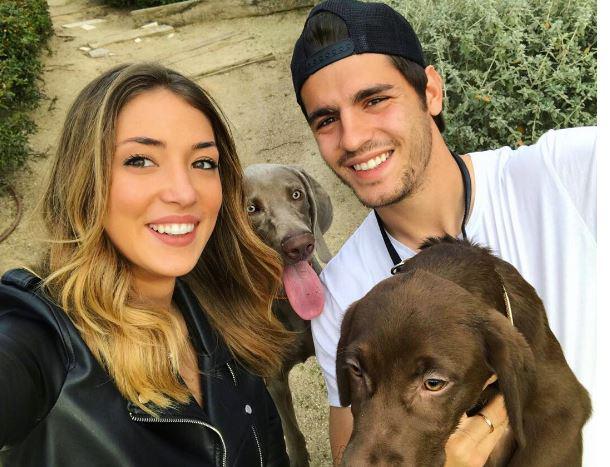 The couple pose with their two dogs