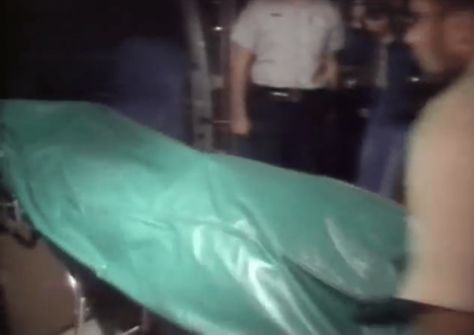  A body bag is loaded into an ambulance after the tragic accident which saw three killed and four more seriously hurt