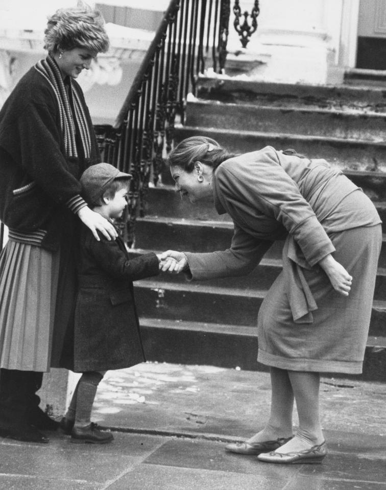  Shaking hands... Prince William is introduced on his first day at school by his mother, Princess Diana