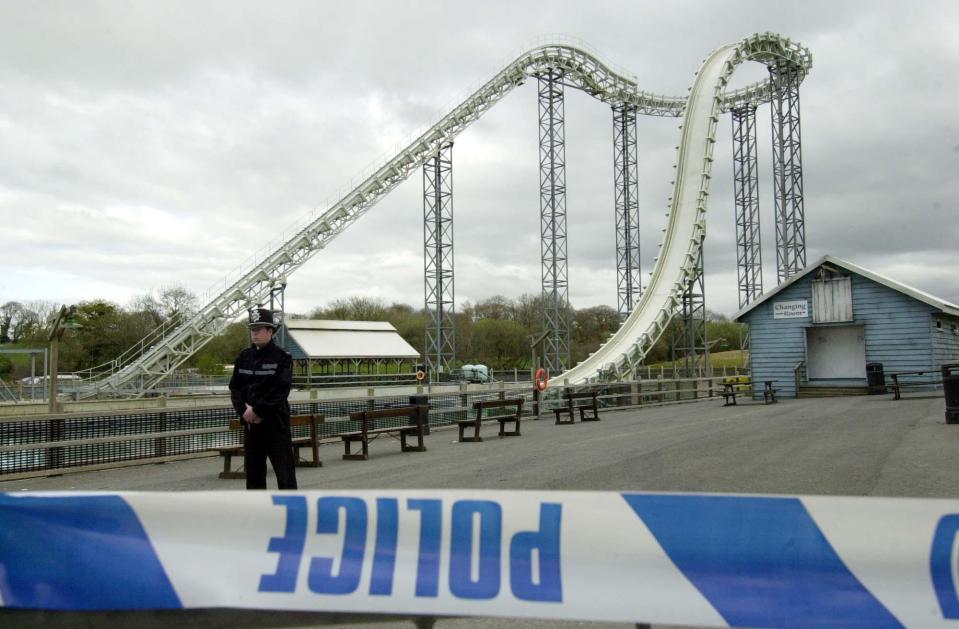  Police officers guard the cordon after closing off the scene of the Hydro ride at Oakwood in Wales in April 2004