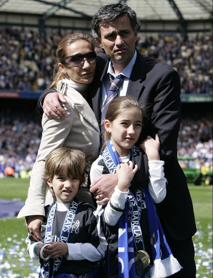 Former Chelsea manager Jose Mourinho hugs his family on the pitch