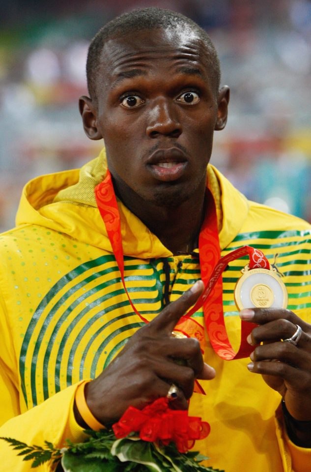  Usain Bolt with his gold medal during the medal ceremony for the Men's 100m at Beijing 2008