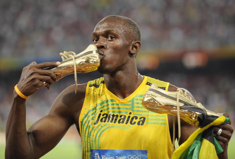  Jamaica's Usain Bolt kisses his shoe after winning the men's 100m final in 2008