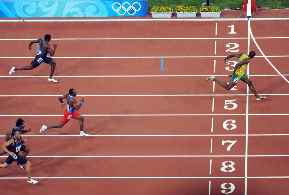  Usain Bolt crosses the finish line streets ahead of his rivals in the Men's 200m  final at Beijing in 2008