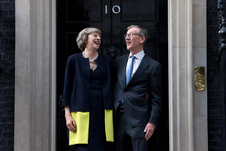  Mrs May and her husband were all smiles at the door of Number 10 as she entered for the first time as PM