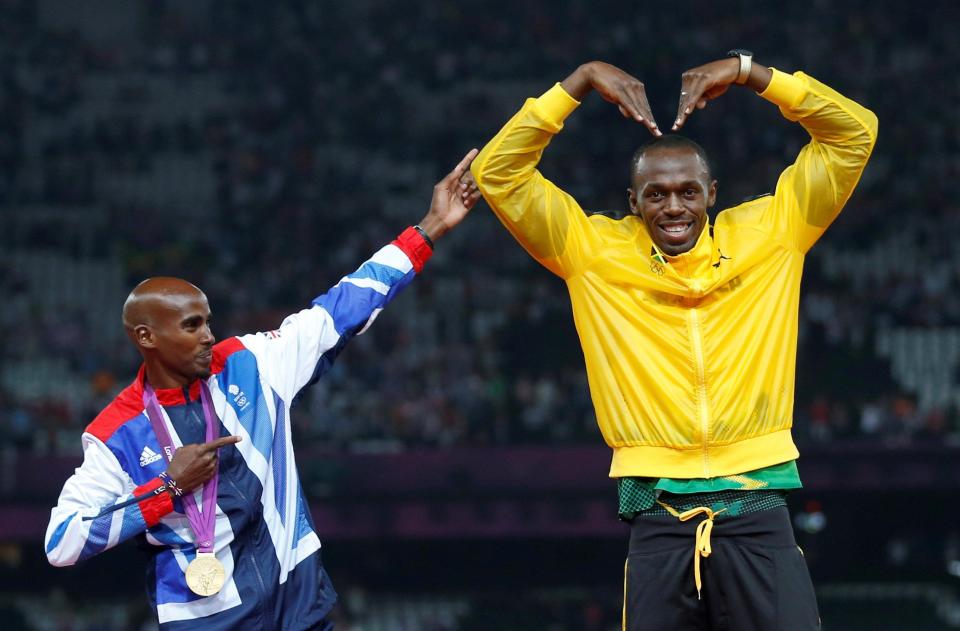  Mo Farah joins Usain Bolt after each receive gold medals at London 2012