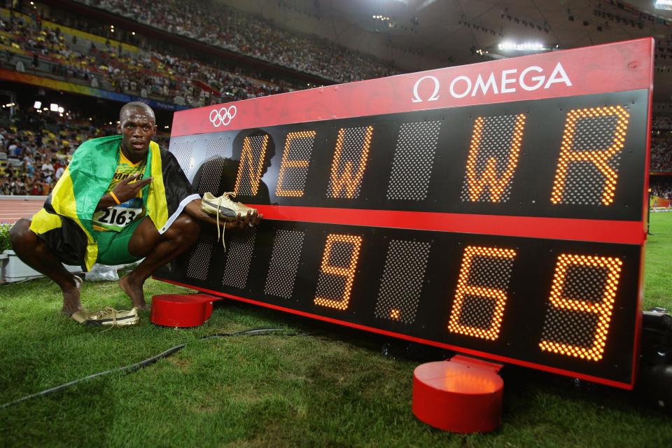  Usain Boltby the clock displaying his winning time after the Men's 100m Final at the Beijing 2008 Olympic Games