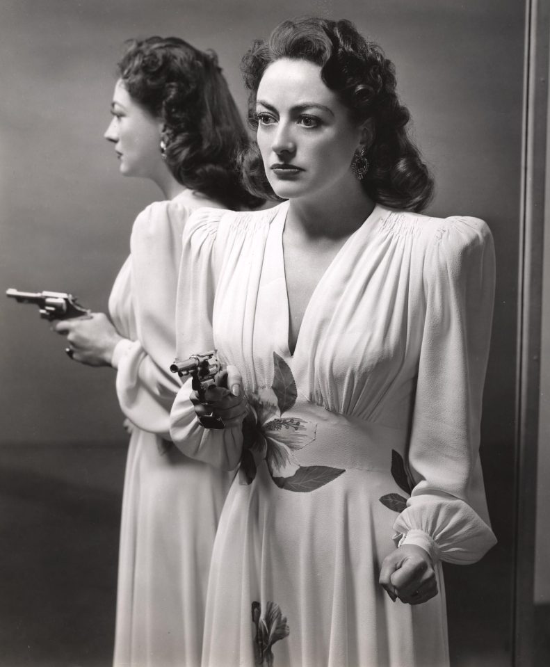  Joan Crawford sports the ultimate power look with shoulder pads and a gun in the 1945 movie Mildred