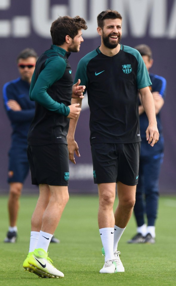 Gerard Pique jokes with Roberto during a Barcelona training session