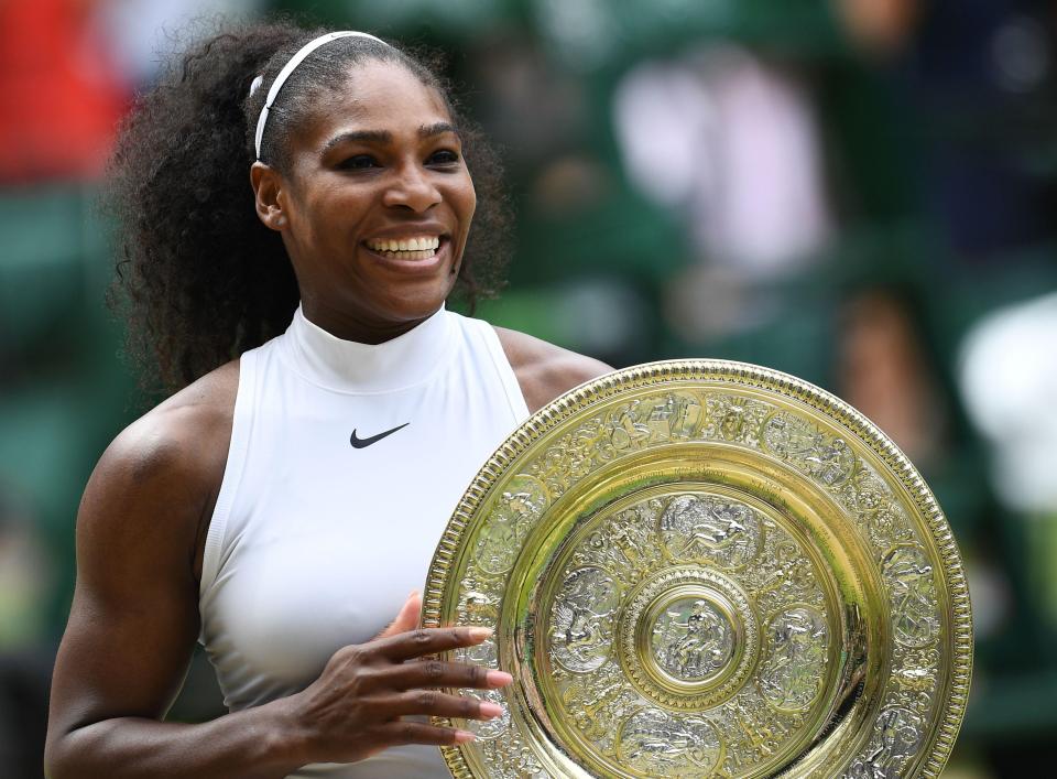 Serena Williams poses with the prolific trophy after her women's singles final victory at Wimbledon 2016