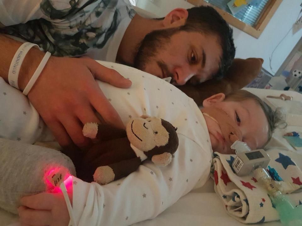  Chris with little Charlie and his toy monkey at his bedside in Great Ormond Street