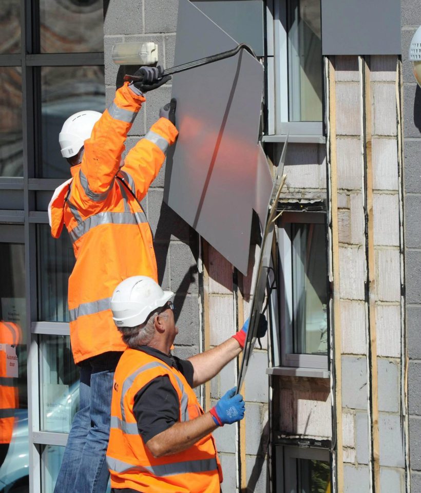 Workers remove cladding from a tower block in Sunderland, as authorities around the country make new safety checks following the London disaster