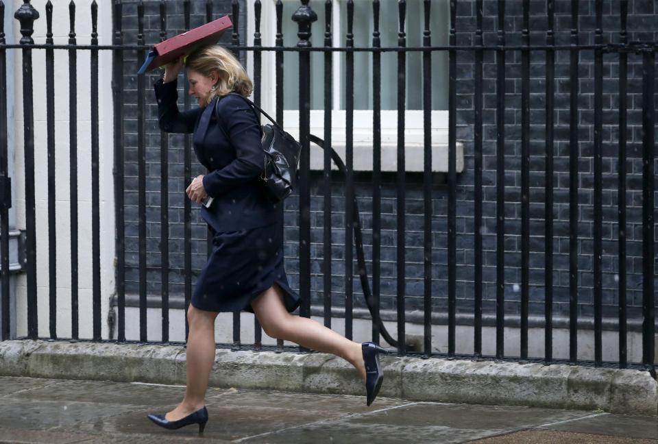  Education Secretary Justine Greening runs for cover following a cabinet meeting