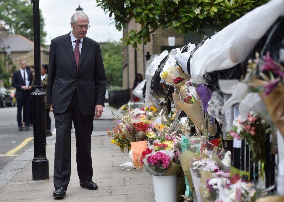 Sir Martin visiting a memorial to the victims of the blaze