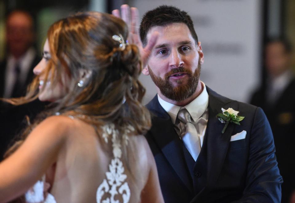 Lionel Messi gives a wave to the crowd and media at in Rosario