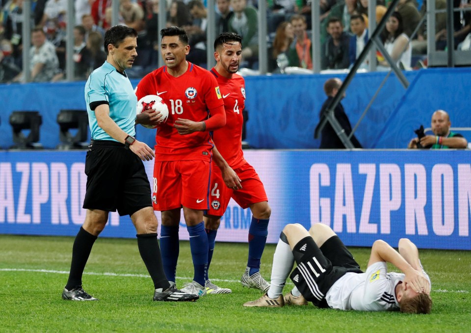 Timo Werner lays on the ground after being elbowed in the face by Chile man Gonzalo Jara