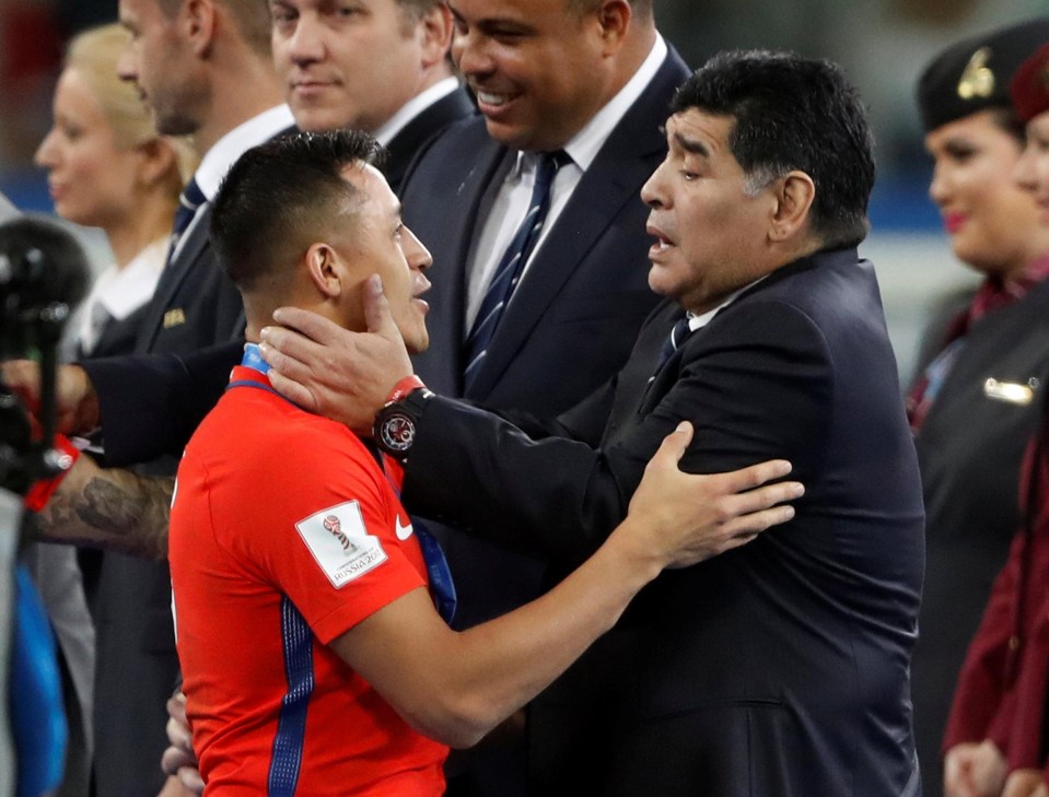 Alexis Sanchez is comforted by Argentinian legend Diego Maradona after Chile lost in the final