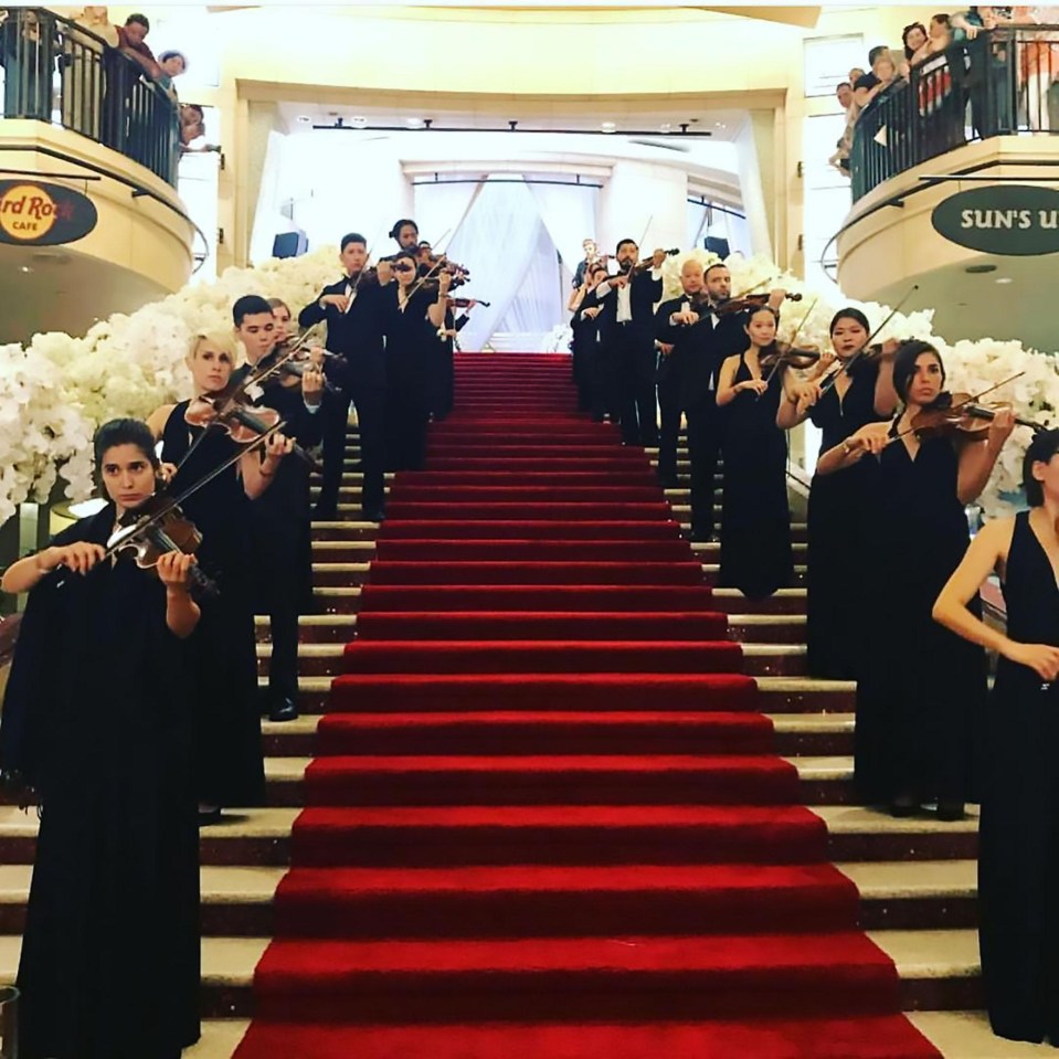 Guests were welcomed into the event by a rows of classic violinists stationed up the stairs clad in a red carpet