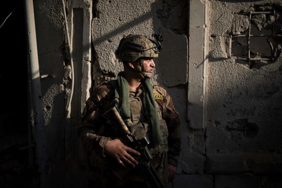  An Iraqi Special Forces soldier stands in position in an alley as Iraqi forces continue their advance