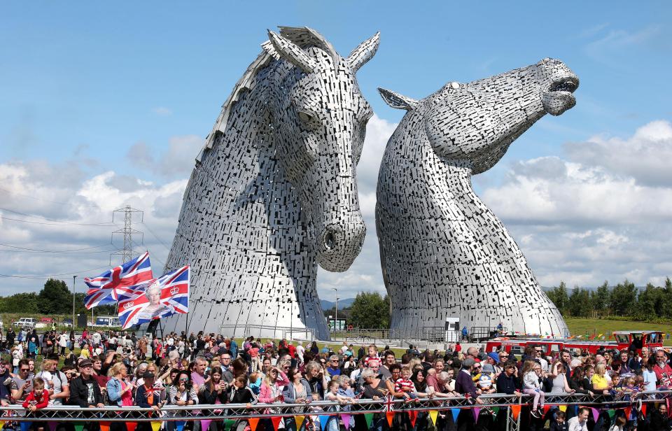  Large crowds of onlookers, including many children, waved Union flags as the royal party passed by