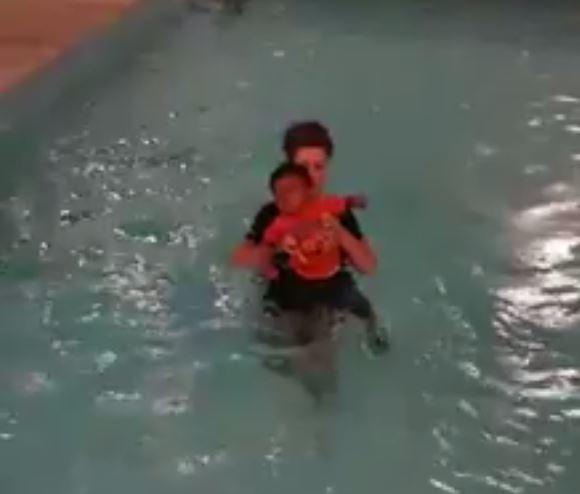 Ina video shared online Mrs Aspinall can be seen repeatedly dropping a toddler into a pool