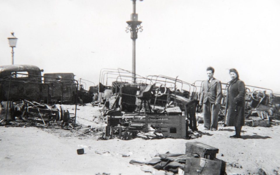  A couple stand next to wrecked trucks in Ostend surveying the scene